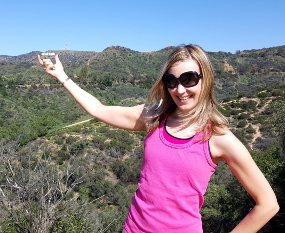 Holding the Hollywood sign view from Griffith park trails LA Los Angeles California