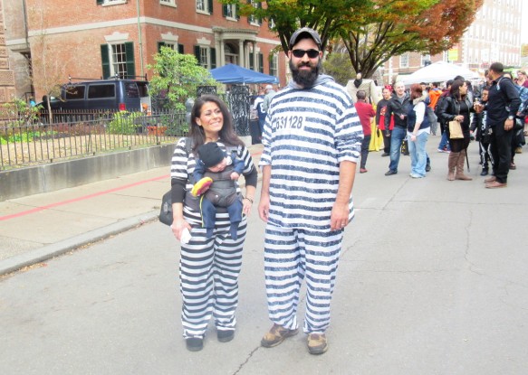 Halloween 2016 in Salem Massachusetts, parents in prisoner costume and baby in police officer costume